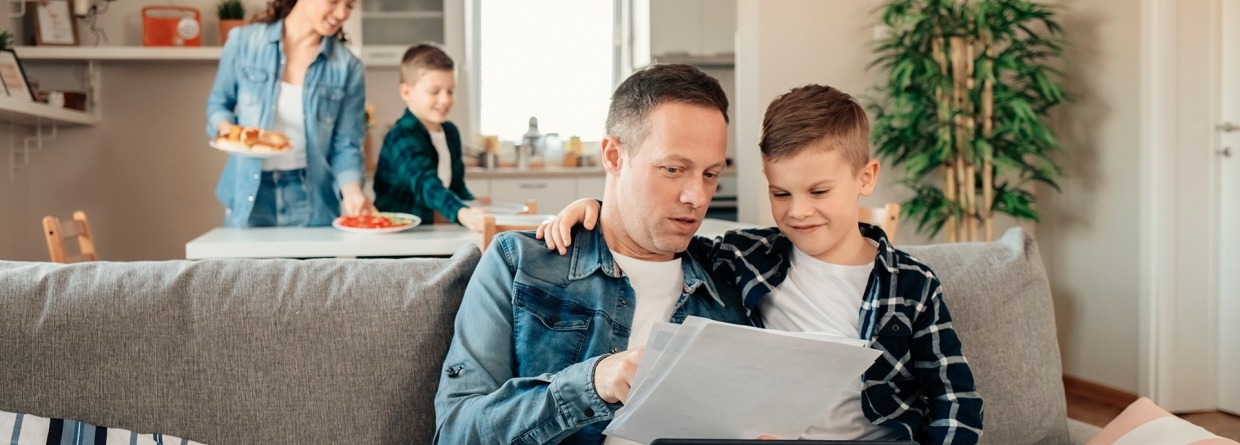 Familie thuis, woonhuisverzekering, schade particulier, gezin, vader, moeder, kind, laptop, bank